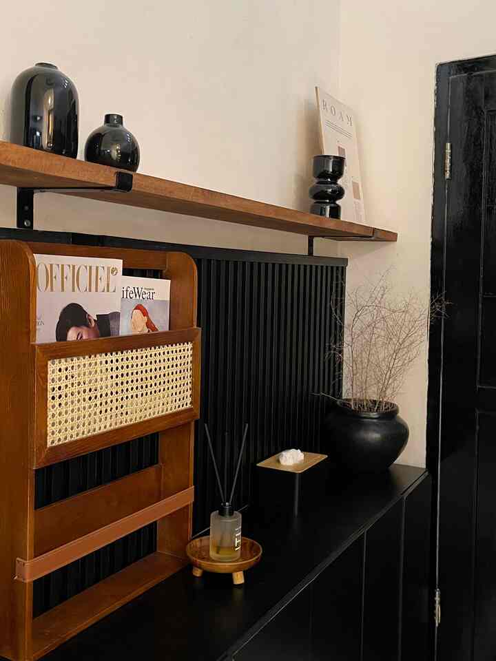 Cozy space featuring wood tone and black storage furniture with decorative items in harmony
