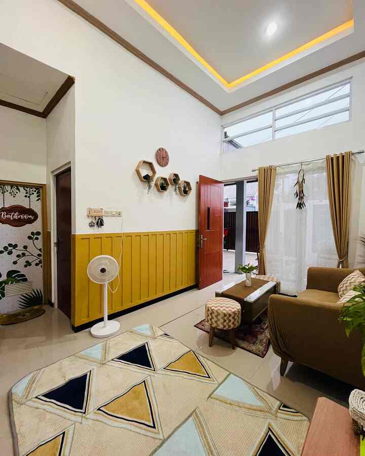 White and yellow toned living room featuring brown sofa and coffee table with a cozy atmosphere