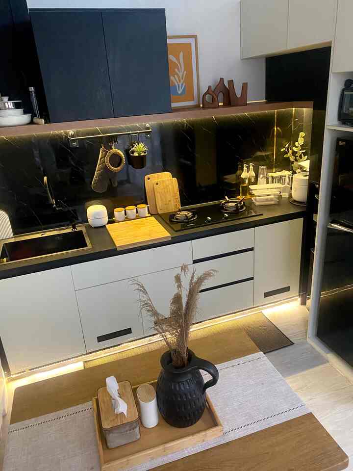 Black and wood tone kitchen space featuring practical tableware and table runner with a cozy atmosphere