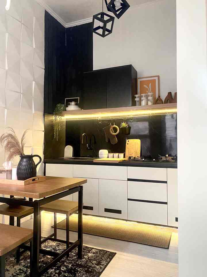 Modern kitchen in white and black tones featuring wood dining table and rugs with minimalistic feel