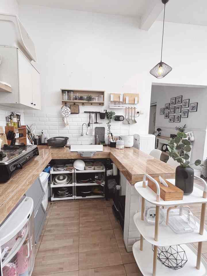 A cozy kitchen featuring natural wood tones and white colors, highlighting effective storage ideas and a modern layout