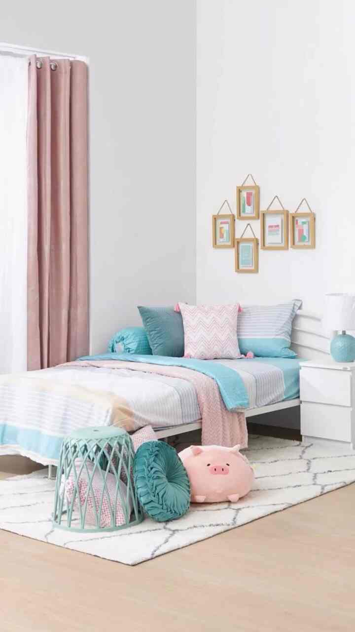 Pastel-toned bedroom featuring white walls, a bed with soft pillows, pink curtains, and cozy decor for a warm atmosphere
