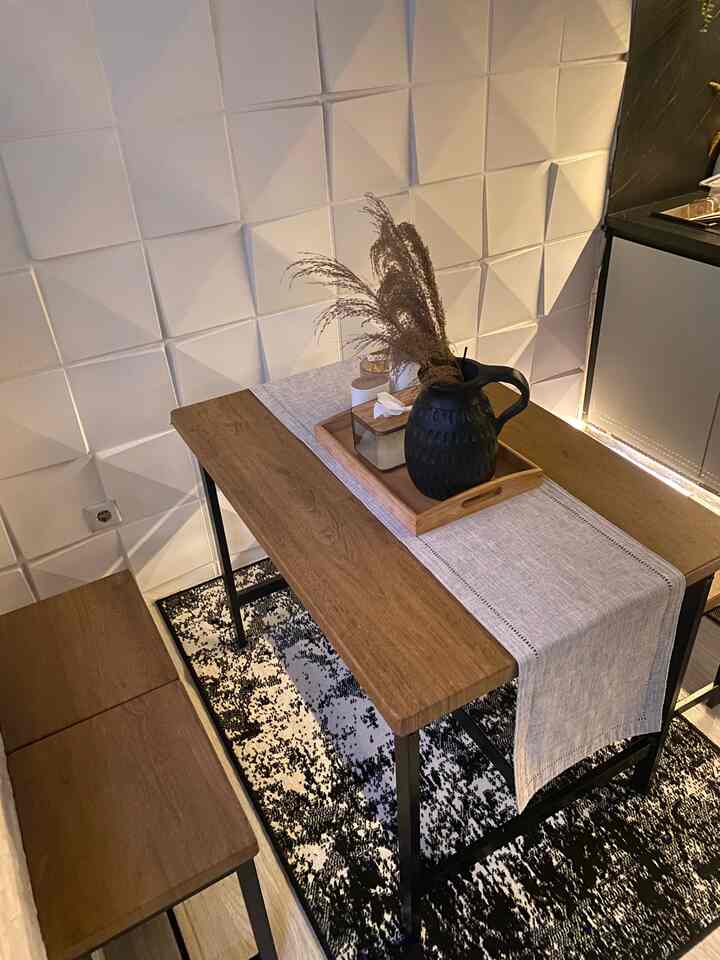 Natural modern dining room with white 3D paneled wall and wood tone table set, featuring minimal and cozy atmosphere