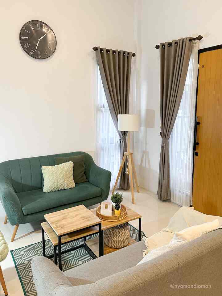 A beige and green toned living room featuring two sofas, a coffee table, and a floor lamp arranged in a natural modern style interior