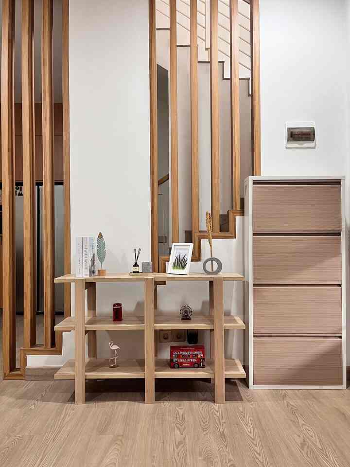 Wood tone and white entrance area featuring wooden shelving and shoe cabinet with a cozy, organized atmosphere