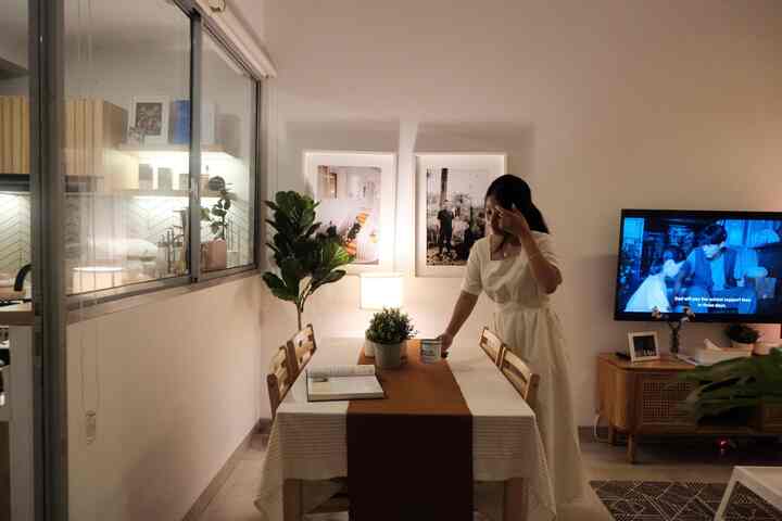 Beige and wood-tone dining room featuring a table, chairs, plants, and a table lamp creating a warm atmosphere