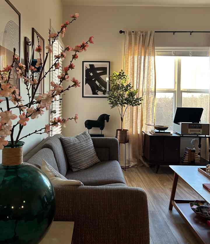 #livingroom #asianinfluence #apartment Would you say that there is some asian style in this room? I kinda think so because of the framed abstract print and the plum blossom floral and the bowl with the sticks laying on top. What do you think?