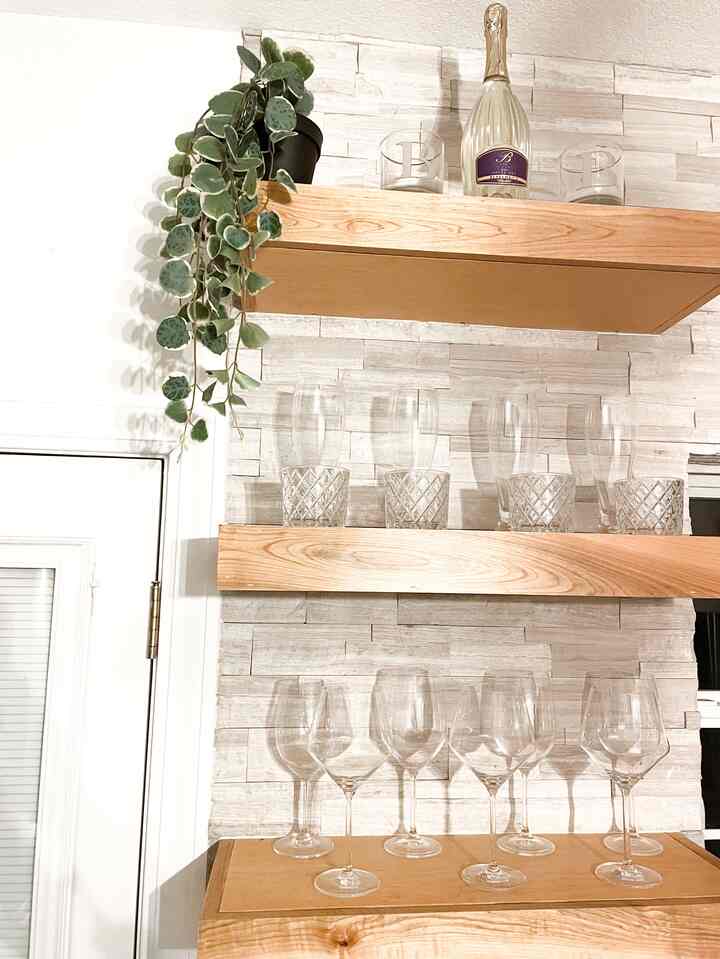 Open shelving concept with a bar-like feel #crateandbarrel #wineglasses #whiskey