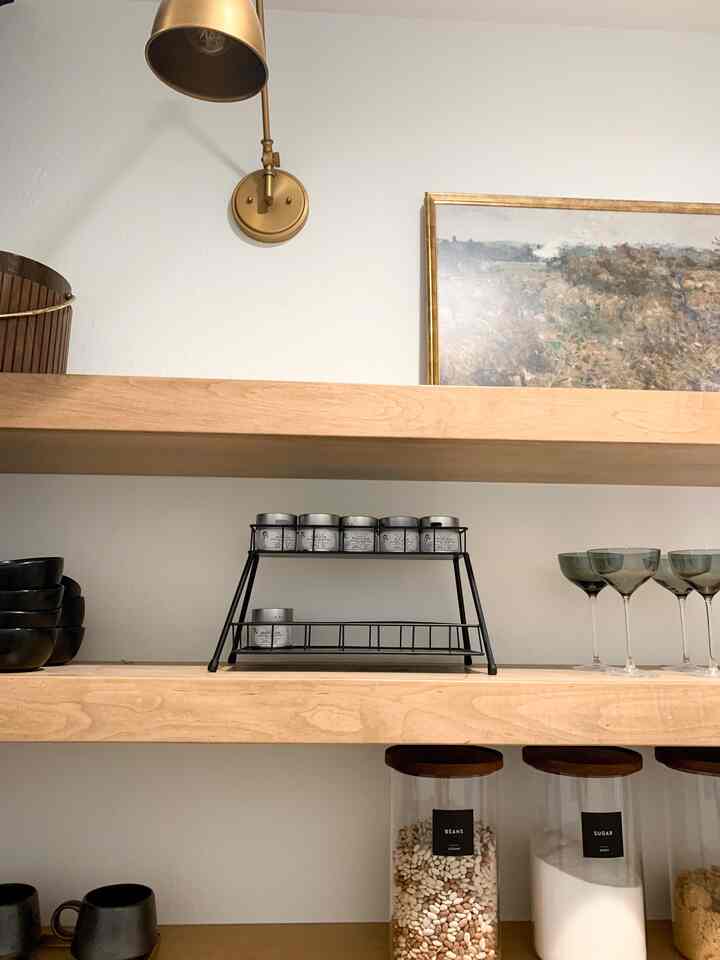 Open shelving in the pantry is pretty and functional with labeled food storage, gourmet seasonings and easy-to-access drinkware.
#pantry #pantryorganization #pantrystorage