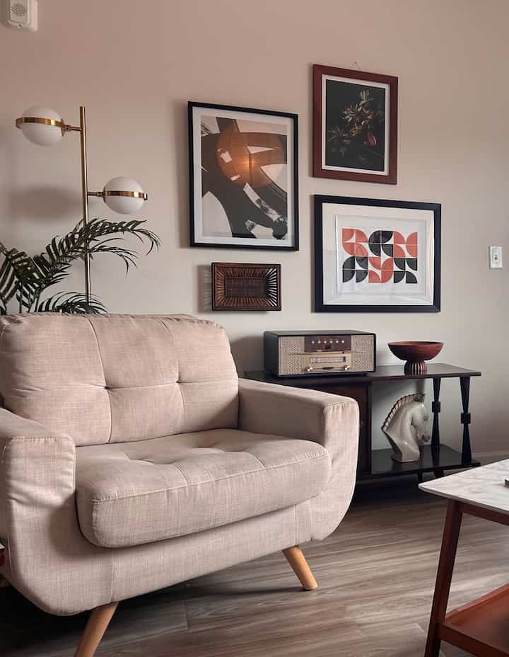 Mid-Century Modern style but with a neutral color scheme #midcentury #modernstyle #retrointerior #neutral #chair #artwall #gallerywall #vintagefurniture 