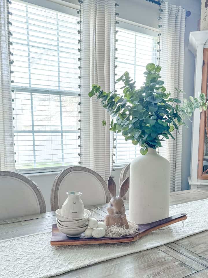 Our dining room has become one of my favorite spaces. The pop of greenery is just what this area needed. #farmhousetable #neutraldecor #springtime