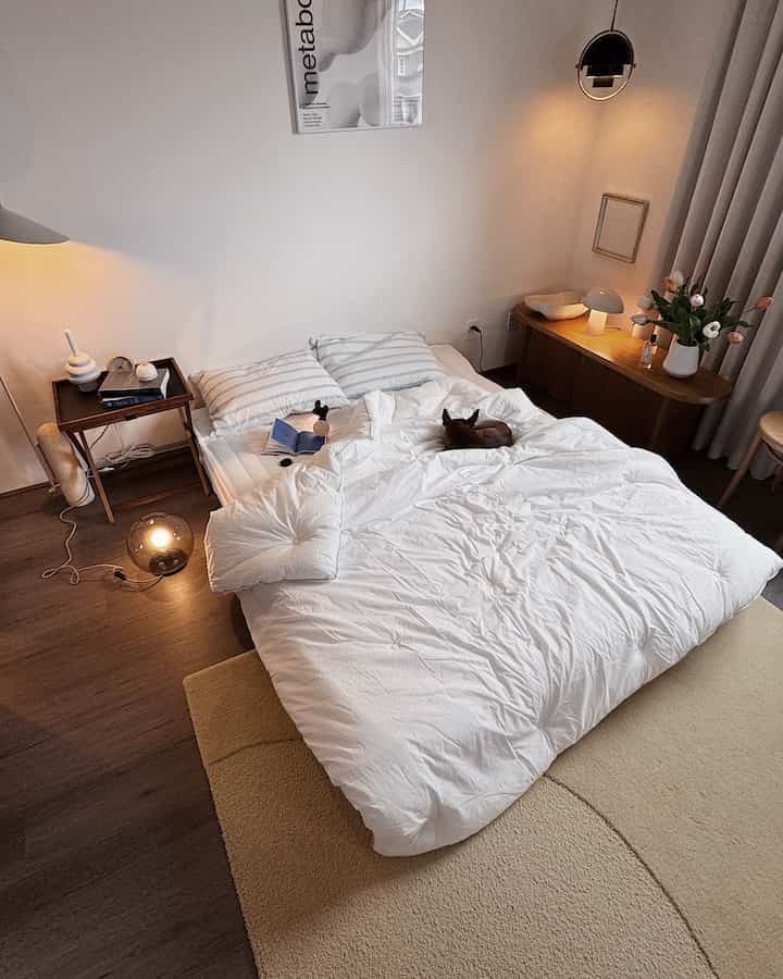 Natural white and brown bedroom featuring a bed with a dog lying on it, gentle lighting creating a cozy atmosphere
