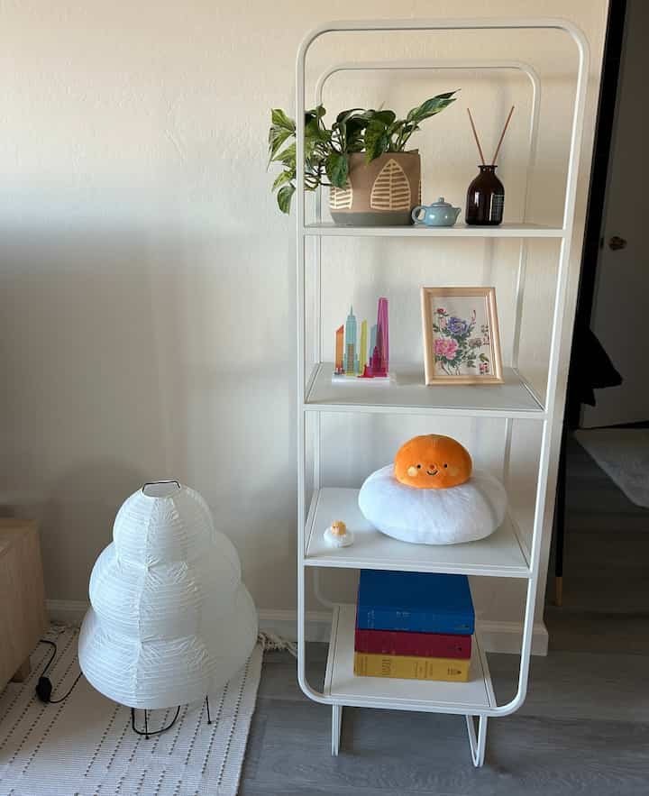 One of my favorite shelves in my space that makes it more modern ✨ #livingroom #urbanoutfitters #alanashelf #modern #postmodern