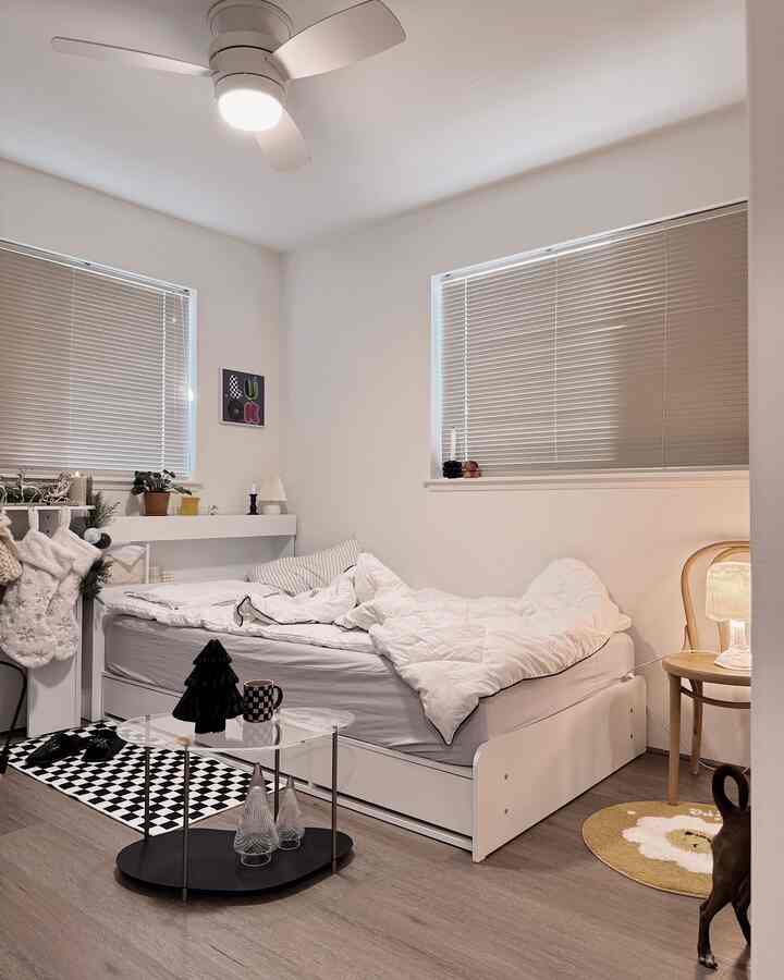 White-toned kids' room featuring a bed, coffee table, and Christmas decorations with cozy atmosphere