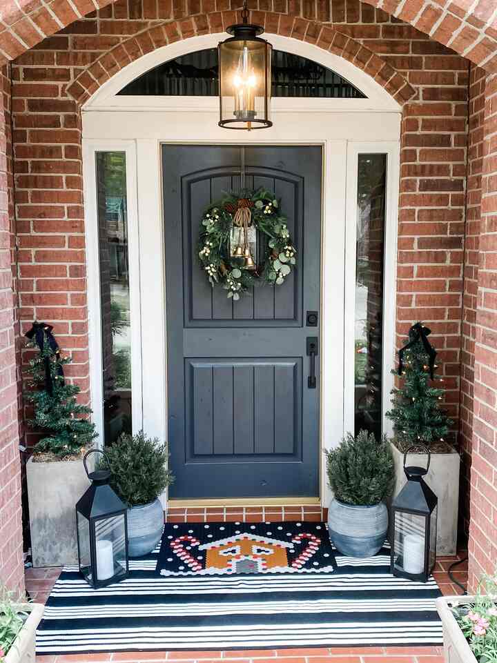 Christmas porch! Tile mat is from letter folk is so fun to change each season!  #porch #porchstyling #christmasporch￼