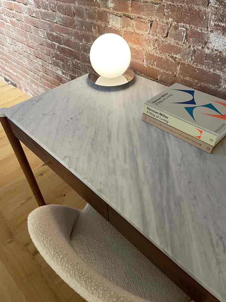 Loving this simple yet dimensional home office area. #boucle #marble #chromelamp