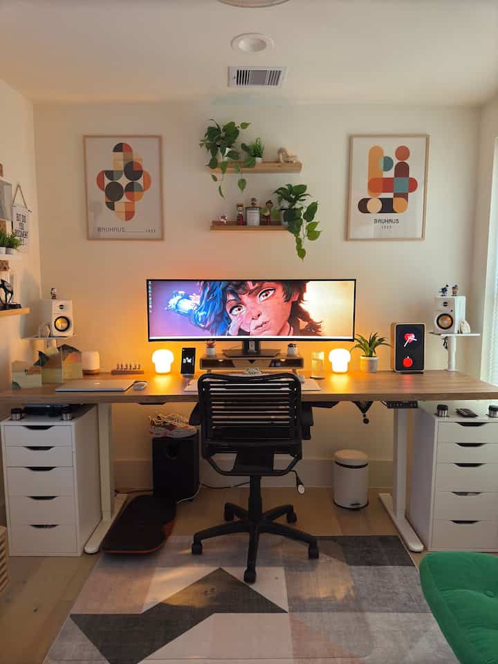 Warm-lit natural modern home office featuring a large wooden desk with white drawer units and organized workspace
