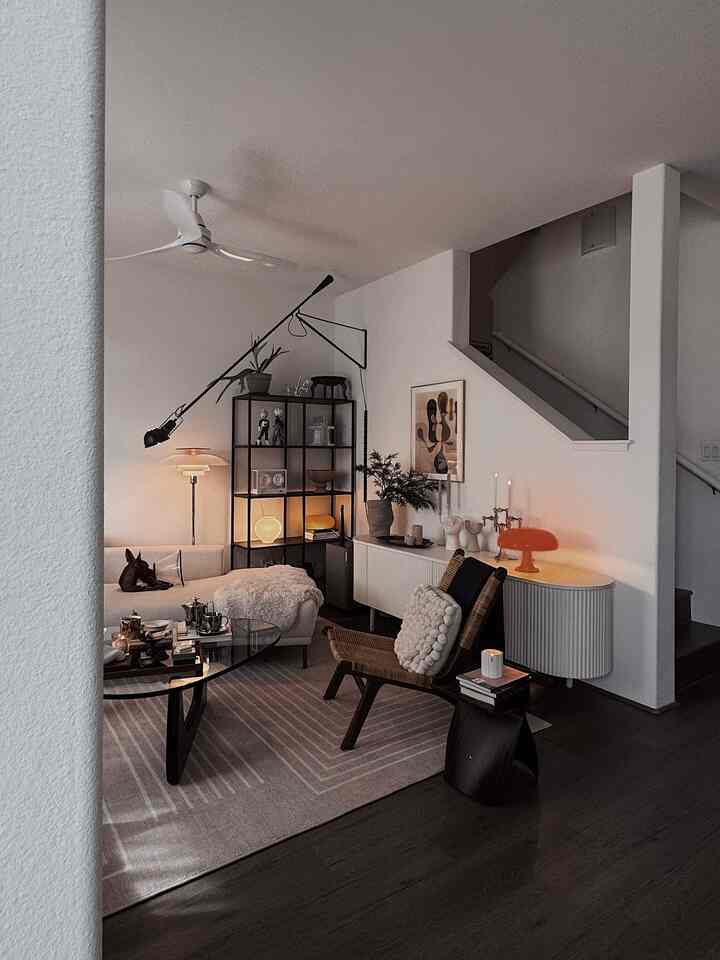 White and brown toned living room featuring sofa, coffee table, and rug with cozy natural ambiance