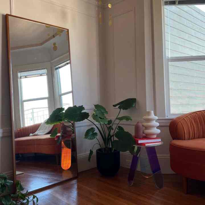 I love using mirrors to make a space feel bigger — heres how i styled it in my postmodern colorful apartment #stylingtip #apartment #colorfulhome