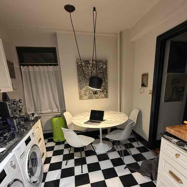 Classic kitchen featuring black and white checkered tile floor and mid-century modern furniture