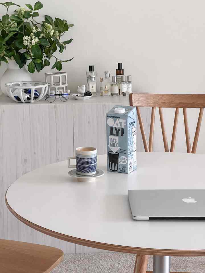 Beige wood tone and white table dining room featuring cozy natural elements with a home cafe atmosphere