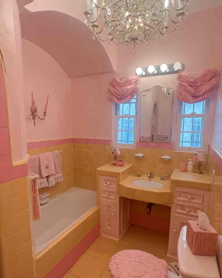 I added some pink stick on tiles to cover some of the vintage tiles in here, and just give it a little Barbie, shabby chic look, while still exposing and showing off the beautiful yellow vintage style. 🎀￼ #pink #bathroom #tissuecover #towel #vintage 