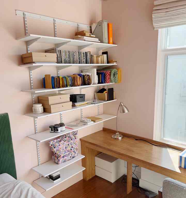 Open shelving is great for fabric and samples and more - seeing them out in the open gets my creative juices running! And inexpensive cardboard boxes are great for the smaller things like paint chips and fabric swatches, or unsightly things like zippers and trimmings

#craftroom #craftspace #modern #wood #pink #bedroomstorage #openshelving