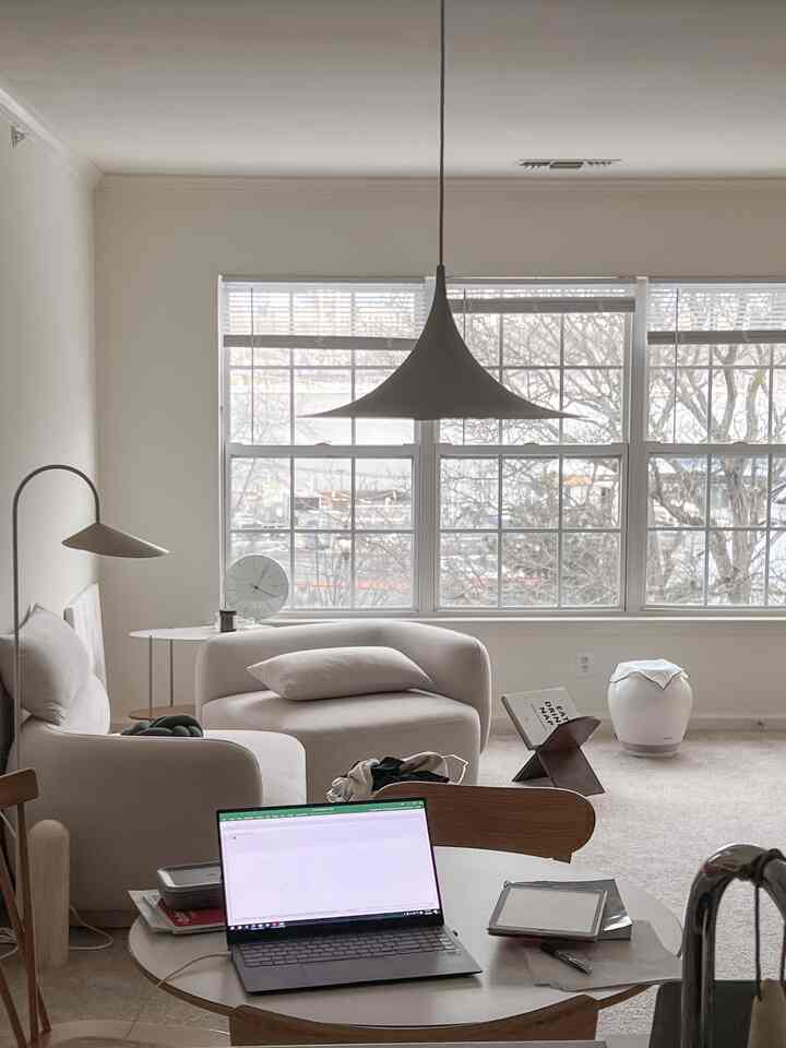 Soft beige-toned living room featuring a beige sofa, coffee table, and pendant light, creating a simple and cozy atmosphere