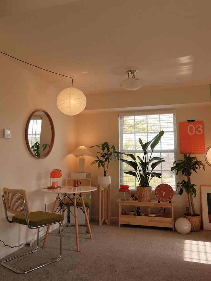 Beige-toned living room featuring orange accents and plants with a warm, natural atmosphere