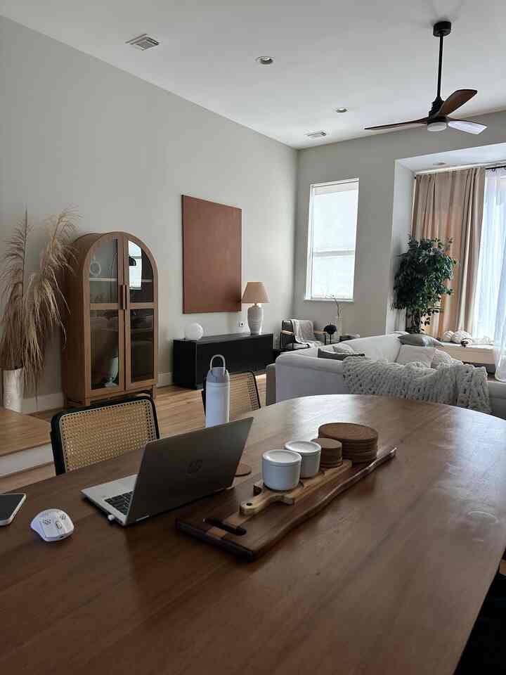 Wood tone natural living and dining room featuring a dining table workspace with cozy elements