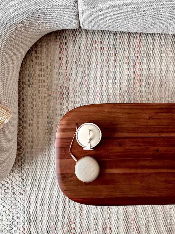  corner, a warm candle, and the perfect playlist. 🎶🕯️ #LafayetteNY #livingroom #curvedsofa #coffeetable #woodtable #arearug