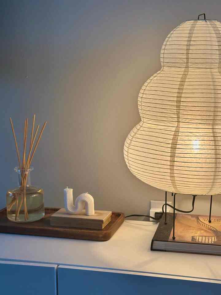 Natural wood tones and soft lighting on a living room table featuring diffuser and candle decor