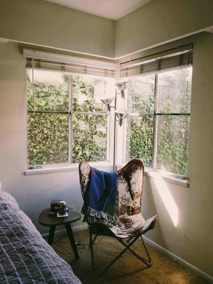 Small corner, big cozy vibes. ☀️✨ This little spot in our bedroom is my go-to for relaxing, especially with the light pouring in through the window. And this chair? Next-level comfy! 😌🛋️ Who else loves a cozy nook? #CozyCorner #SunlitSpace #MinimalLiving #ComfyVibes #HomeAesthetic #SmallSpaceLiving #RelaxAndUnwind #InteriorInspo #NaturalLightLover #BedroomNook #SoftAndSerene
