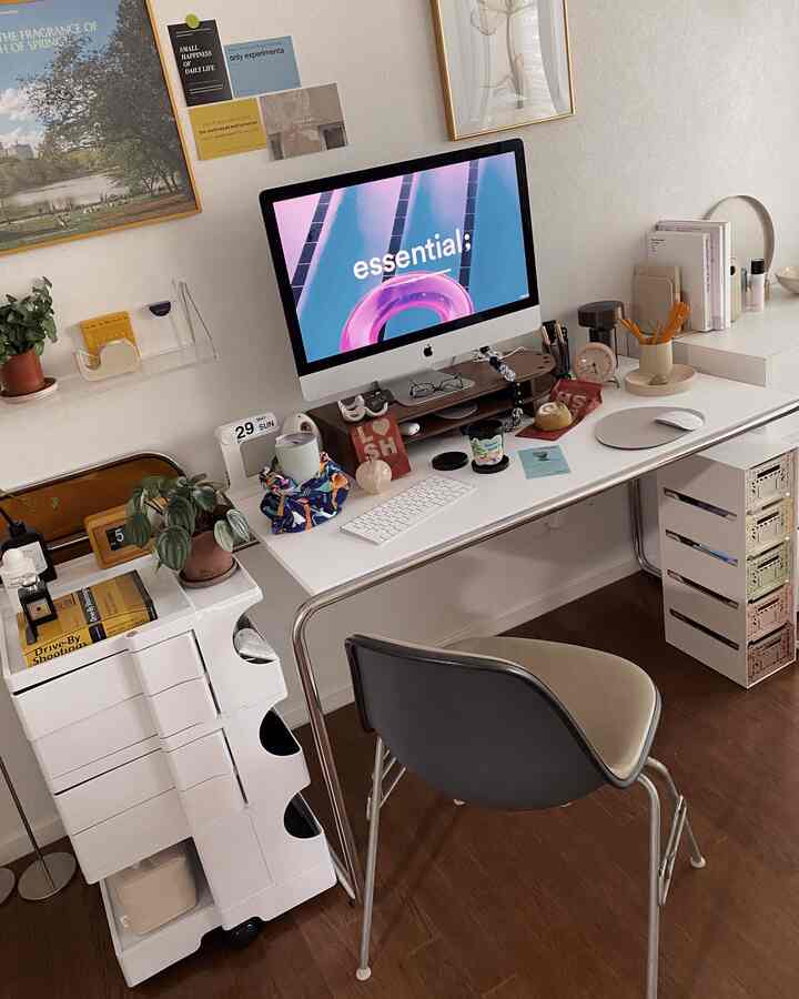 Modern home office space in white and brown tones featuring an iMac and organized desk accessories with a clean atmosphere