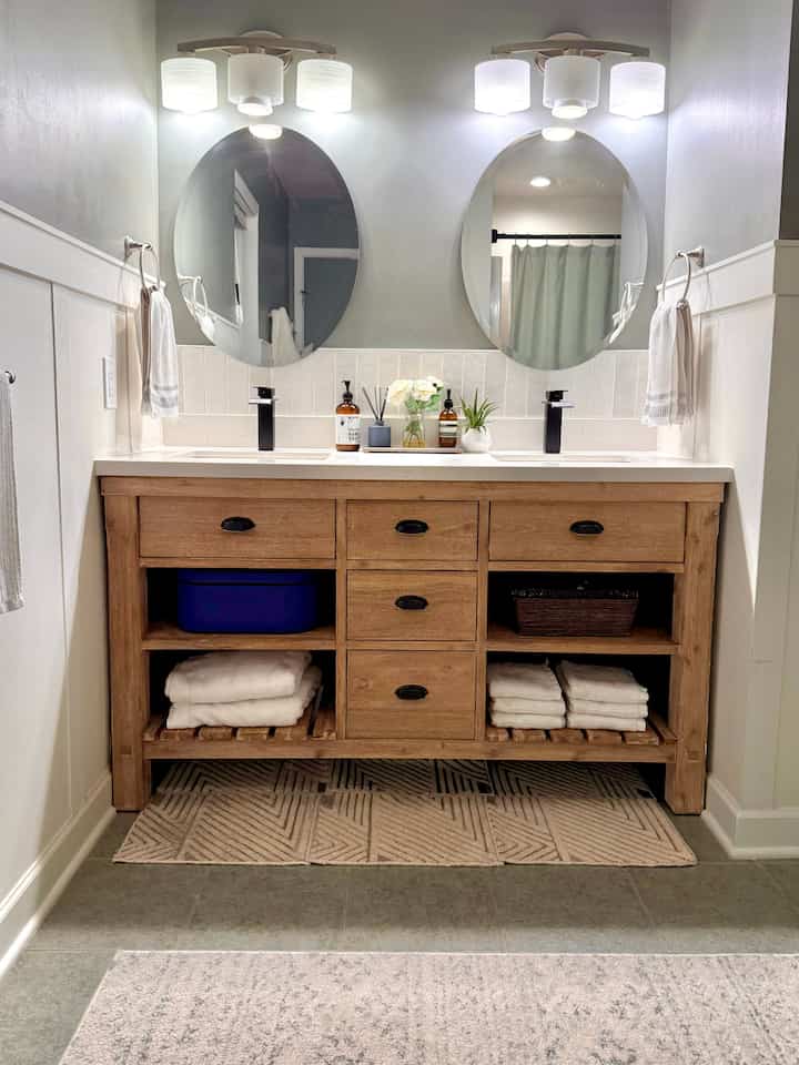 Natural bathroom featuring white walls and a wood tone vanity with white quartz countertop
