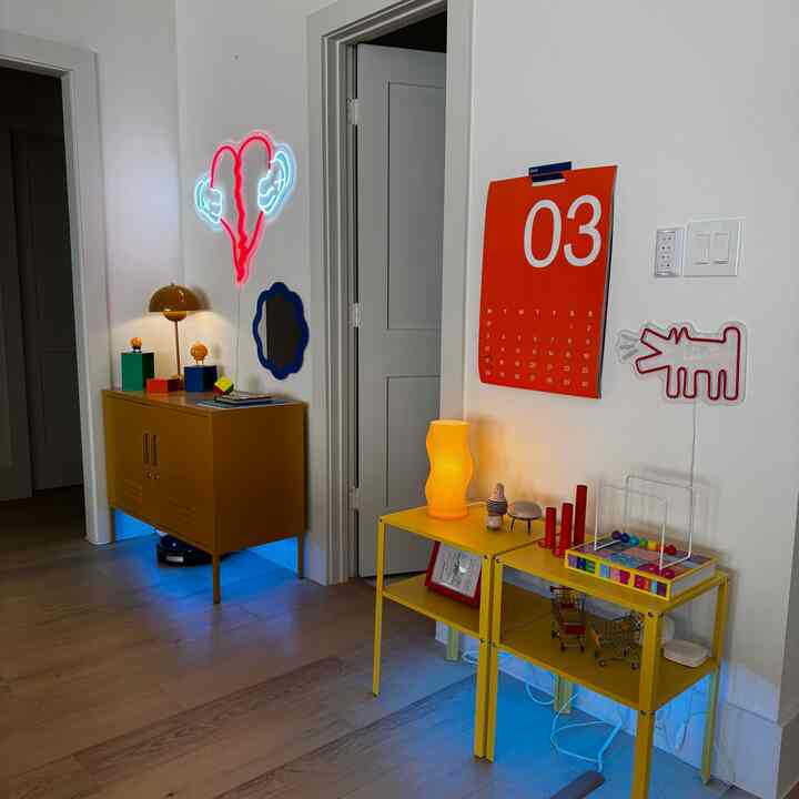 A trendy living room corner with yellow furniture and distinctive wall lighting