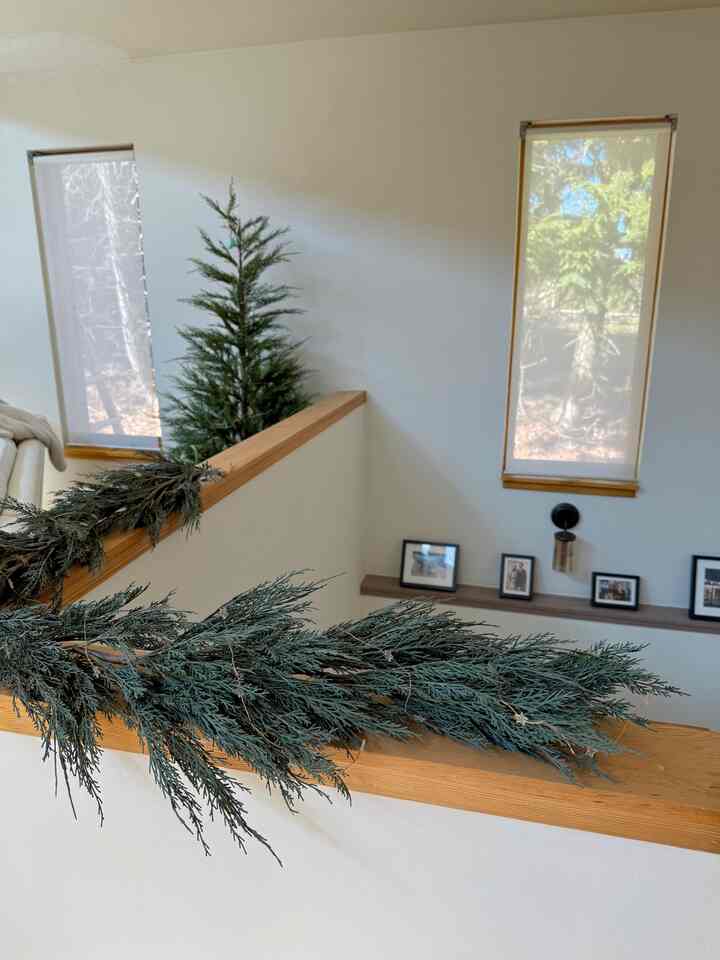 I have a half wall separating the stairs to the living room. During the holiday season, I purchased a cypress tree and garland and have kept them up ever since because I love the natural ambiance they create.
#enterance #stairs #livingroom #wood #natural #modern #cozy 