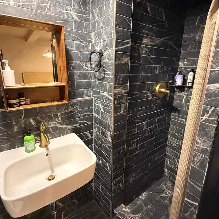 Dark tiles with brass hardware always 🖤 
#bathroomstorage #bathroomcleaning 