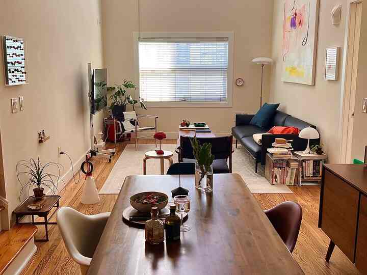 White and brown toned living and dining room featuring modern furniture with a warm and cozy atmosphere