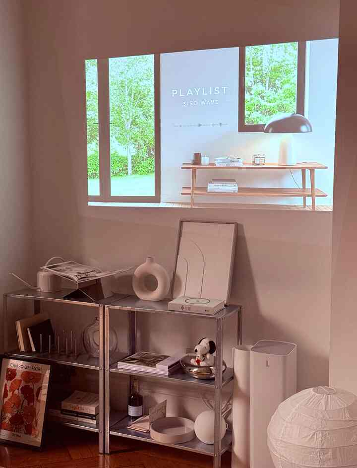 Getting a projector instead of a TV in a small studio apartment saves space and keeps the clean aesthetics. I was also not sure about drilling a hole in my old brownstone apartment to hang my TV and the projector solved this issue and I can watch movies as big as I want to! #projector #apartmentinterior #rentfriendly #livingroominterior 