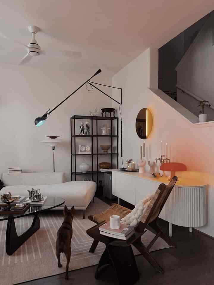 White-toned living room featuring modern furniture and mood lighting creating a cozy atmosphere