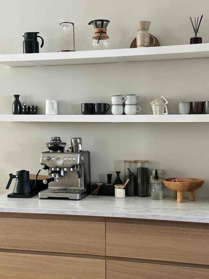The cutest lil coffee bar with all the neutral stoneware 💫 #oak #WoodInterior #coffee #dininginterior #coffeebar #japandi #mcm 