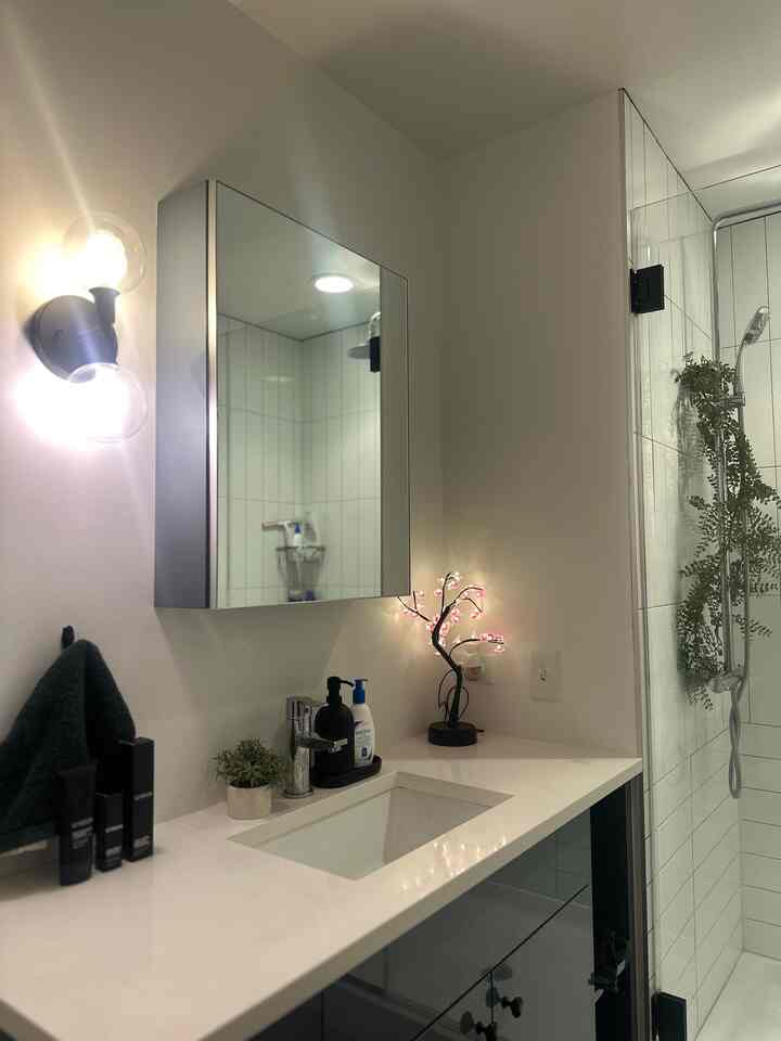 the less cluttered my bathroom is, the better i feel !!! utilize storage to hide things is a gamechanger! #minimalbathroom #cozy #shower #bathroominterior 