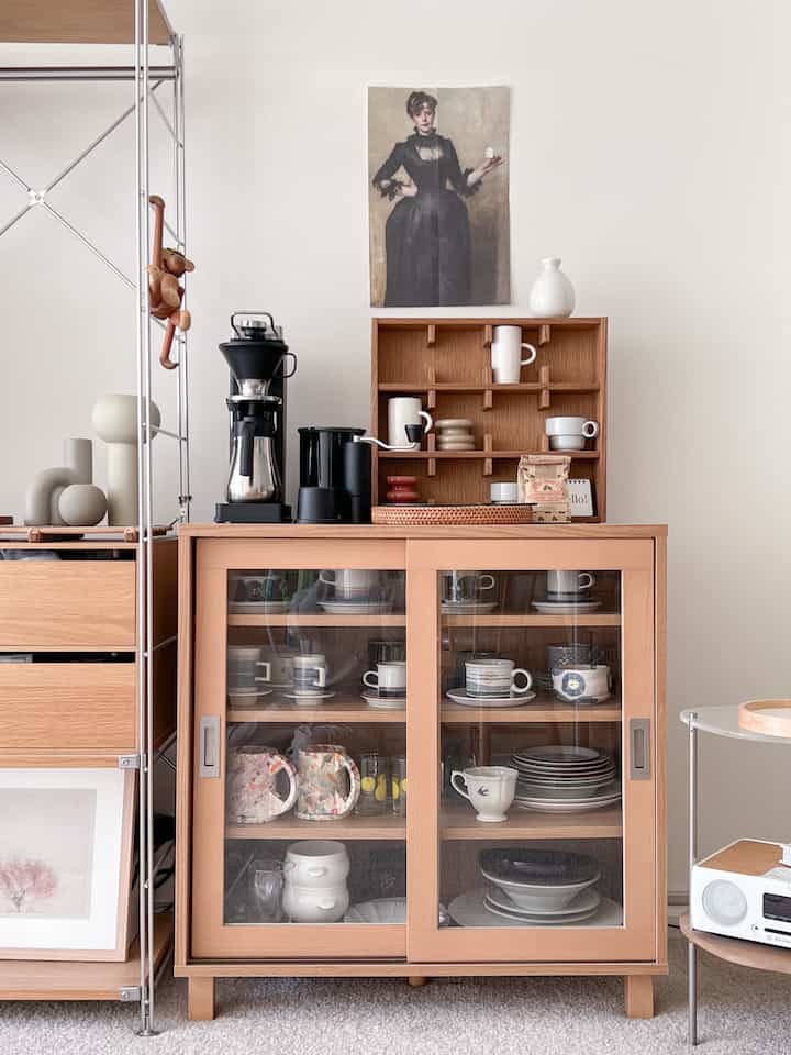 Natural wood tone kitchen space featuring a poster and coffee machine with a cozy home cafe atmosphere