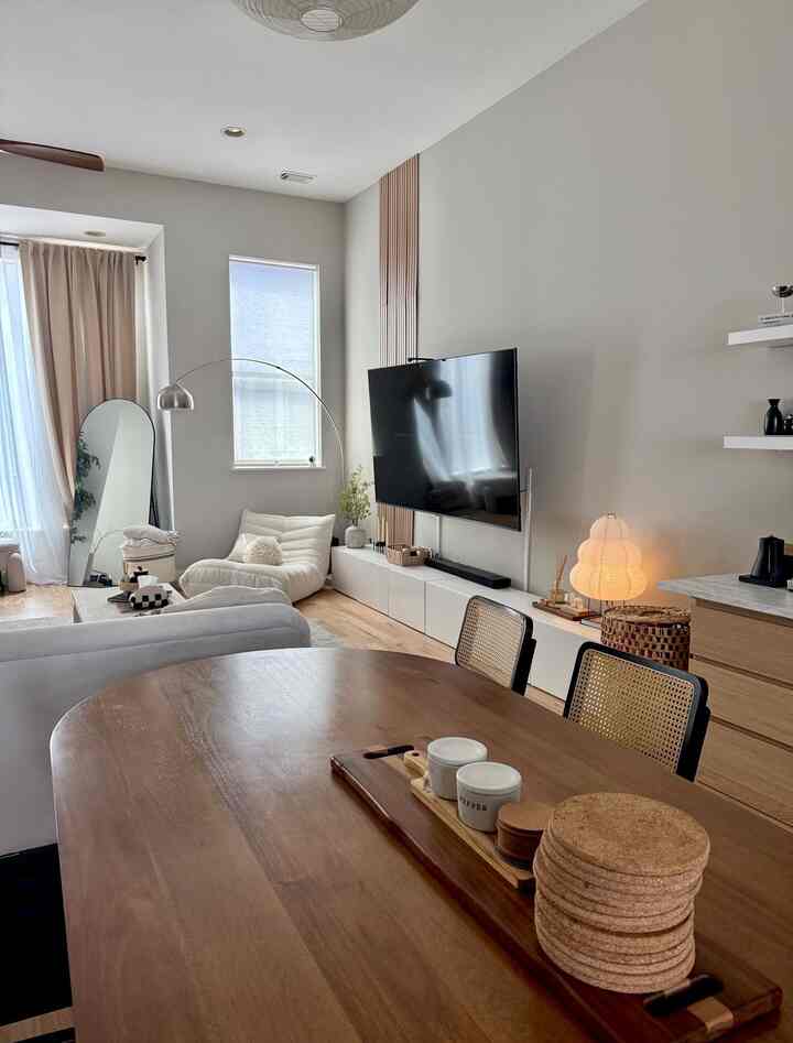 Wood tone and white living and dining room with cozy, harmonious Japandi style interior