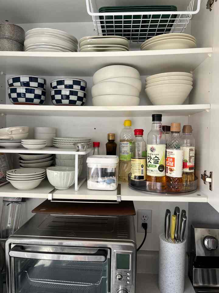 How to organize a small kitchen? Use every bit of space! ✨ These under-cabinet storage racks saved so much space for organizing dishes — total game changer! #smallkitchen #kitchenorganization #spacesaving #storagesolutions #organizedliving #kitchendecor #homedetails #modernhome #homeorganization #kitcheninspo