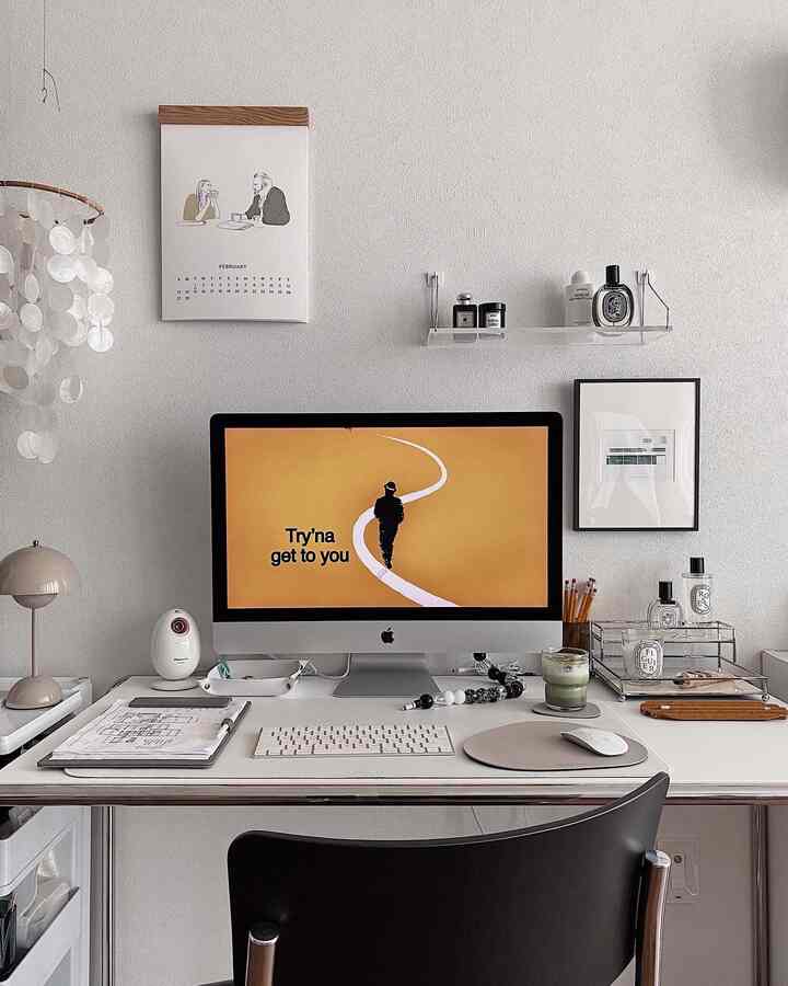 White and gray toned compact home office featuring a modern desk and chair with a clean remote work setup