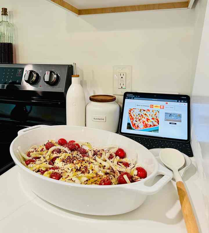 White-tone kitchen featuring a modern ceramic ovenware dish with kitchen utensils, creating a clean and stylish space