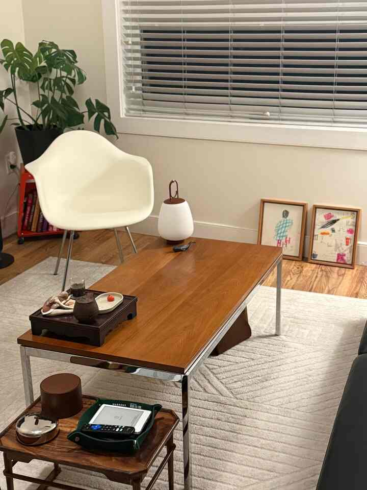 Natural tones and white-themed living room featuring a wooden coffee table and white armchair in a cozy setting