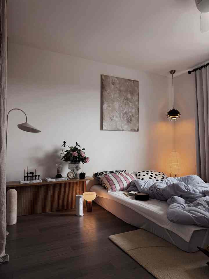 Modern bedroom with brown flooring and white walls, featuring a low bed and soft mood lighting for a cozy atmosphere